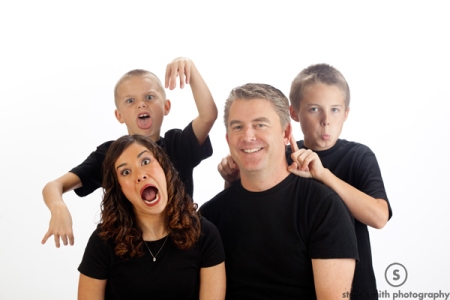 Portrait of family of four making funny faces